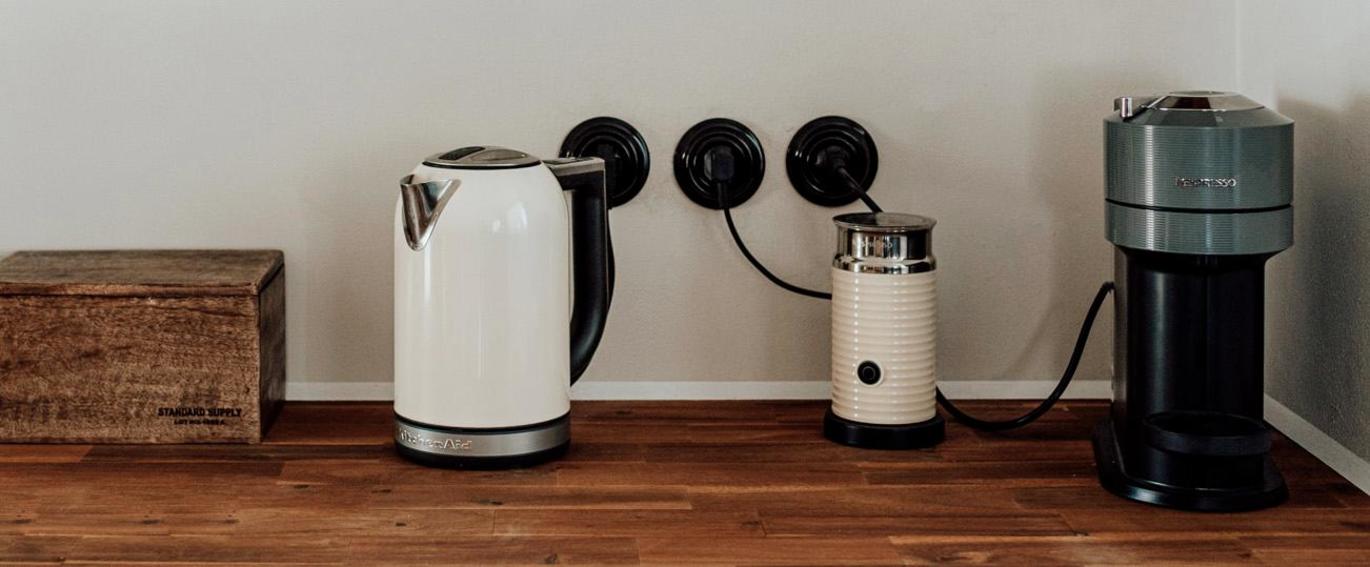 Kuchyňská linka ve stylu wabi sabi a černé porcelánové vypínače